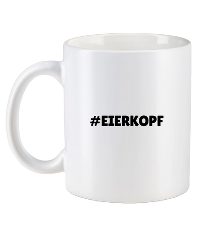 Weiße Tasse mit schwarzem Hashtag-Schriftzug „#EIERKOPF“ auf der Rückseite – schlichtes, humorvolles Design für Fans.







